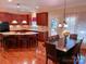 Well-appointed kitchen featuring a central island with seating, warm wood cabinetry, and hardwood floors at 15494 Donnington Dr, Charlotte, NC 28277