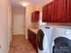 Functional laundry room with ample cabinet storage, countertop space, and modern washer/dryer units at 15494 Donnington Dr, Charlotte, NC 28277
