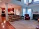 Spacious living area blending into kitchen, with fireplace and large windows offering natural light and airy feel at 15494 Donnington Dr, Charlotte, NC 28277