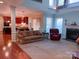Open concept living room with a view of the kitchen and a cozy fireplace at 15494 Donnington Dr, Charlotte, NC 28277