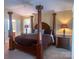 Spacious main bedroom with a four-poster bed and large bedside tables at 15494 Donnington Dr, Charlotte, NC 28277