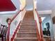 Carpeted staircase featuring white spindles and wooden banister at 15494 Donnington Dr, Charlotte, NC 28277