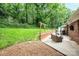 Lush backyard featuring a patio with comfortable seating and barbecue grill, perfect for outdoor living at 1571 10Th Street Nw Pl, Hickory, NC 28601