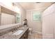 Cozy bathroom with granite countertop, modern fixtures, shiplap, and tiled floors at 1571 10Th Street Nw Pl, Hickory, NC 28601