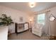 Charming Bedroom with a crib, soft lighting, a cozy armchair, and neutral decor at 1571 10Th Street Nw Pl, Hickory, NC 28601