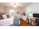 Bright bedroom featuring hardwood floors, ceiling fan, and dresser at 1571 10Th Street Nw Pl, Hickory, NC 28601