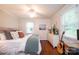 Bright bedroom with hardwood floors, ceiling fan, dresser, and lots of natural light at 1571 10Th Street Nw Pl, Hickory, NC 28601