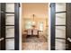 View through double doors of dining area, showcasing a wooden table and stylish decor at 1571 10Th Street Nw Pl, Hickory, NC 28601