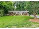 Charming single-story brick home with a manicured front yard and a welcoming blue front door at 1571 10Th Street Nw Pl, Hickory, NC 28601