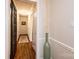 Hallway featuring hardwood floors, neutral walls, with a decorative vase and stylish accents at 1571 10Th Street Nw Pl, Hickory, NC 28601