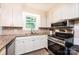 Modern kitchen features granite counters, stainless steel appliances, and ample cabinet space at 1571 10Th Street Nw Pl, Hickory, NC 28601