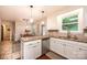 Well-lit kitchen featuring white cabinets, granite countertops, stainless steel appliances, and an adjacent dining area at 1571 10Th Street Nw Pl, Hickory, NC 28601