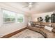 Bright living room features a cozy leather couch, large window, ceiling fan, and modern decor at 1571 10Th Street Nw Pl, Hickory, NC 28601