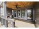 Spacious covered porch with a fireplace, recessed lights, and exterior access door at 1625 Club Rd, Charlotte, NC 28205