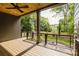 Covered back porch featuring wood ceiling, ceiling fan, and metal railings overlooking the backyard at 1625 Club Rd, Charlotte, NC 28205