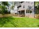 Large backyard with a wooden fence, and a covered patio at 1625 Club Rd, Charlotte, NC 28205