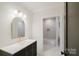 Modern bathroom featuring gold hardware, sleek mirror and neutral color palette at 1625 Club Rd, Charlotte, NC 28205
