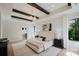 Serene bedroom featuring exposed beams, soft lighting, and a luxurious en-suite bathroom at 1625 Club Rd, Charlotte, NC 28205