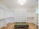 Bright walk-in closet featuring shelving and a bench at 1625 Club Rd, Charlotte, NC 28205
