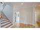 Bright foyer with hardwood floors and a staircase leading to the upper level at 1625 Club Rd, Charlotte, NC 28205