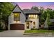 Exterior of the home with a brick facade, an arched entryway, and a two-car garage at 1625 Club Rd, Charlotte, NC 28205