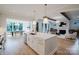 Modern kitchen with a large island, gold fixtures, and an open view to the dining and living areas at 1625 Club Rd, Charlotte, NC 28205