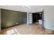Beautiful living room with wood accent wall, hardwood floors, and glass paneled doors at 1625 Club Rd, Charlotte, NC 28205