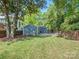 Green backyard with a fire pit and grass lawn at 1720 Chatham Ave, Charlotte, NC 28205