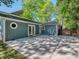 Back of house showing French doors and stone patio with surrounding greenery at 1720 Chatham Ave, Charlotte, NC 28205