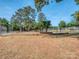 Outdoor basketball courts with mature trees and perimeter fencing provide recreation and exercise at 1720 Chatham Ave, Charlotte, NC 28205