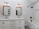 Updated bathroom with double vanity, subway tile shower, and modern fixtures at 1720 Chatham Ave, Charlotte, NC 28205