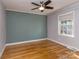 Bedroom with hardwood floors, ceiling fan, and a large window offering natural light at 1720 Chatham Ave, Charlotte, NC 28205