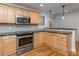 Modern kitchen with stainless steel appliances, granite countertops, and stylish hardwood flooring at 1720 Chatham Ave, Charlotte, NC 28205
