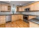 Updated kitchen features stainless steel appliances, granite countertops, and light wood cabinetry at 1720 Chatham Ave, Charlotte, NC 28205
