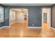 Open living space with hardwood floors, arched doorway, and views into other rooms at 1720 Chatham Ave, Charlotte, NC 28205