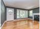 Bright living room featuring hardwood floors, large windows, and a classic fireplace at 1720 Chatham Ave, Charlotte, NC 28205