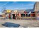 The lively Smooth Monkey features a colorful exterior, flags, and inviting outdoor area at 1720 Chatham Ave, Charlotte, NC 28205