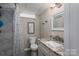 Updated bathroom with marble shower, vanity, modern lighting, and framed welcome decor at 1761 Arden Dr, Lincolnton, NC 28092