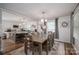 Elegant dining area adjoining the kitchen, featuring a rustic table and modern lighting at 1761 Arden Dr, Lincolnton, NC 28092