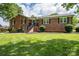A well-maintained brick home with a green lawn and a welcoming entrance at 1761 Arden Dr, Lincolnton, NC 28092