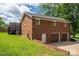 Two-car garage with a brick exterior and a well-maintained lawn at 1761 Arden Dr, Lincolnton, NC 28092