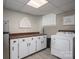 Spacious laundry room with lots of white cabinets, butcher block countertop, and modern appliances at 1761 Arden Dr, Lincolnton, NC 28092