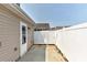 View of backyard and patio with white vinyl fence and door at 1890 Sandal Brook Rd, Fort Mill, SC 29707