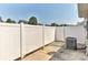Backyard features white fencing, concrete patio and AC unit at 1890 Sandal Brook Rd, Fort Mill, SC 29707