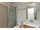 Bathroom featuring a marble countertop, frosted shower door, and tile surround at 1890 Sandal Brook Rd, Fort Mill, SC 29707