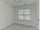 Neat bedroom with neutral walls, plush gray carpet, window blinds and ample natural light at 1890 Sandal Brook Rd, Fort Mill, SC 29707