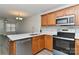 Bright kitchen featuring stainless steel appliances, white countertops, and wooden cabinets at 1890 Sandal Brook Rd, Fort Mill, SC 29707