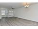 Inviting living room with large windows and hardwood floors and modern ceiling fan at 1890 Sandal Brook Rd, Fort Mill, SC 29707