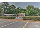 Community pool area featuring a pool house, lounge chairs, and greenery, perfect for relaxation and recreation at 1890 Sandal Brook Rd, Fort Mill, SC 29707