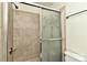 Shower featuring decorative glass sliding door and tile surround at 1890 Sandal Brook Rd, Fort Mill, SC 29707